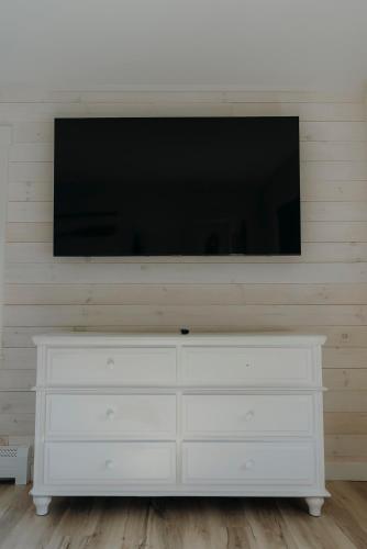 a white dresser with a television on top of it at Bingham Motor Inn in Bingham