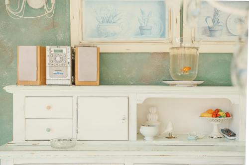 a white shelf with items on top of it at La casa nel borgo in San Nicola Arcella