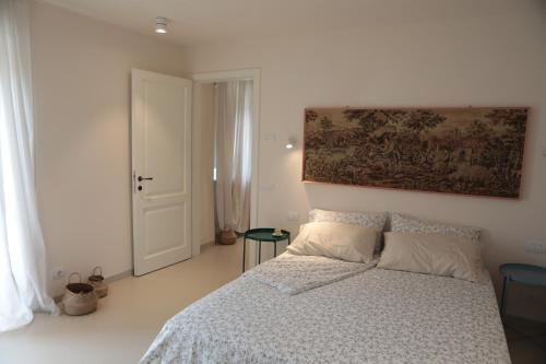 Agriturismo I Casali في Fiumaretta di Ameglia: غرفة نوم بسرير ودهان على الحائط