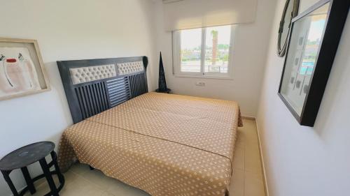 a small bedroom with a bed and a window at La Bovila Apartment with exceptional yard in Platja  d'Aro