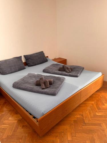 Duas camas com almofadas castanhas por cima em Apartman Bari Petrcane em Petrcane