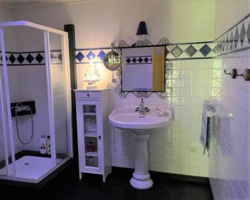a small bathroom with a sink and a shower at Casa da Pedra - Turismo Rural in Bragado