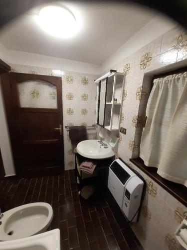 a bathroom with a sink and a toilet and a mirror at Chalet Niki BELLAGIO in Bellagio