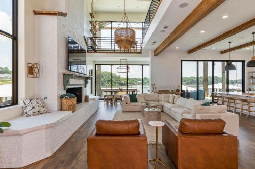 a living room with couches and a fireplace at Sunset Rock at Lake Martin in Alexander City