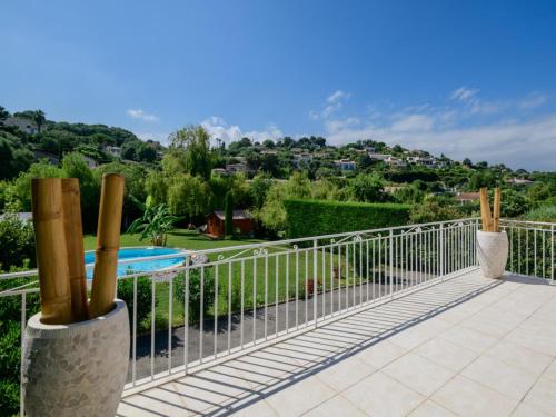 a balcony with a view of a swimming pool at Villa Hibiscus in Antibes