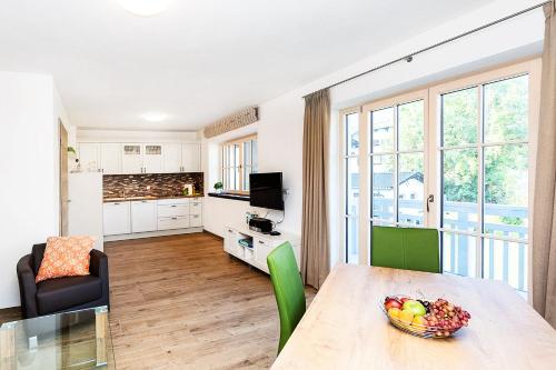 a living room with a table with a bowl of fruit at Ferienwohnung Höfle in Garmisch-Partenkirchen