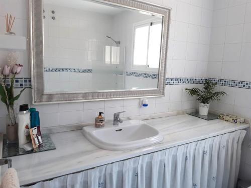 a bathroom with a sink and a mirror at El Capricho de Espartinas in Espartinas