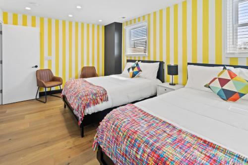 a hotel room with two beds and a chair at Stylishly Renovated 5-Bedroom Home in AC - Perfect for Groups and Families in Atlantic City