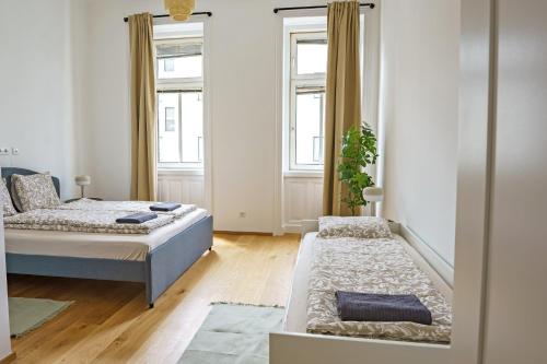 Una cama o camas en una habitación de Vienna City Apartments Belvedere