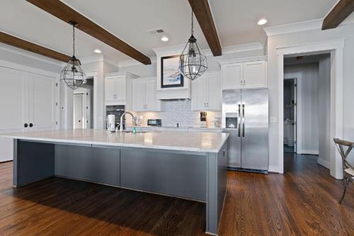 a large kitchen with white cabinets and a large island at Easy Street 