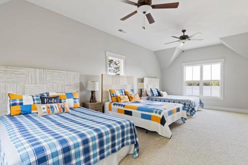a bedroom with two beds and a ceiling fan at Easy Street 