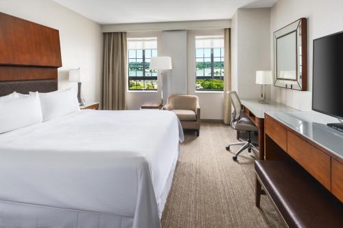a hotel room with a bed and a desk at The Westin Portland Harborview in Portland