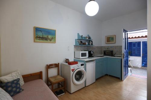 a kitchen with a washing machine and a washer at Bella Vista in Batsi