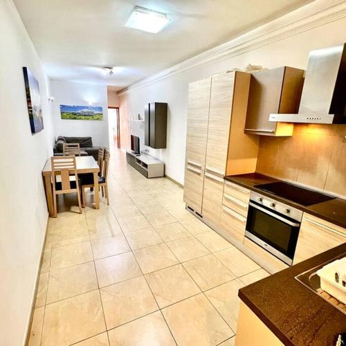 a large kitchen with a table and a dining room at Gzira Smart 1 Bedroom Apartment in Il-Gżira