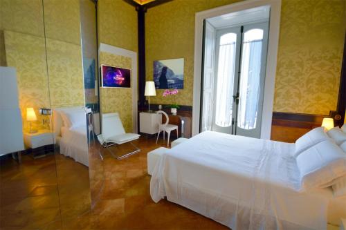 a bedroom with a white bed and a glass door at Maiori Dream Rental in Maiori