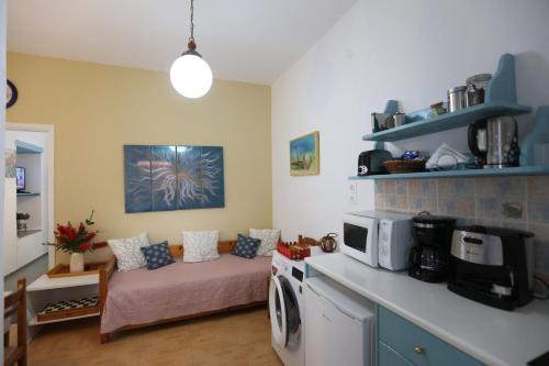 a living room with a bed and a microwave at Bella Vista in Batsi