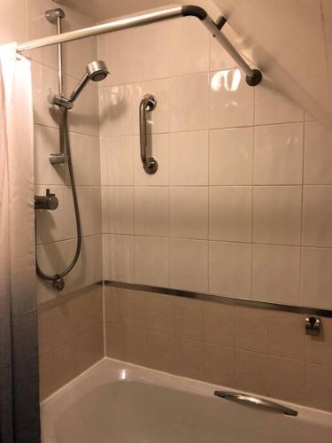 a bathroom with a shower and a bath tub at Stunning Apartment In The Heart of Broadway in Broadway