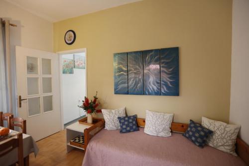a bedroom with a bed and a clock on the wall at Bella Vista in Batsi