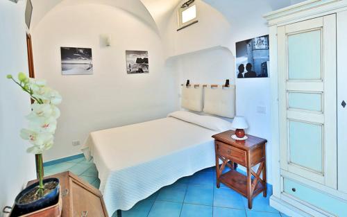a bedroom with a bed and a table with a lamp at Aiano Bed&Breakfast in Capri