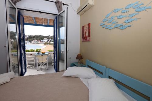 a bedroom with a bed and a view of the ocean at Bella Vista in Batsi