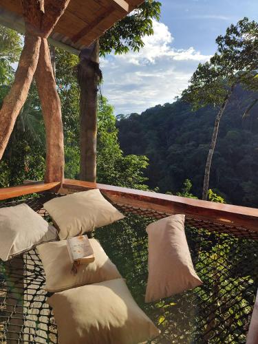 a group of pillows sitting on a balcony with a view at Wild Wasi Lodge - Adventures - Guided Tours in Puyo