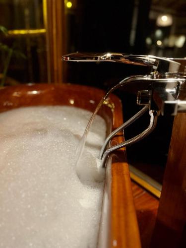 a bath tub filled with water with a faucet at Wild Wasi Lodge - Adventures - Guided Tours in Puyo