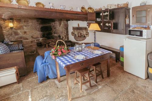 a kitchen with a table with flowers on it at Cottage São Veríssimo in Figueiredo