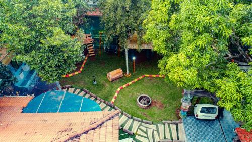 an aerial view of a backyard with a car in the yard at Belljem Homes -your own private resort -1 BHK FF in Trichūr