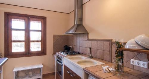 a kitchen with a sink and a stove at Finca Cari in Can Picafort