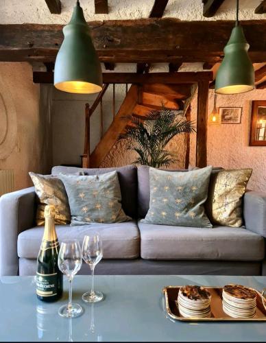 a living room with a couch and two wine glasses at Maison Marcks Champagne in Ay