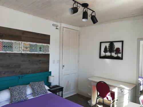 a bedroom with a purple bed and a desk at HOTEL Boutique Casablanca Adrogué in Adrogué