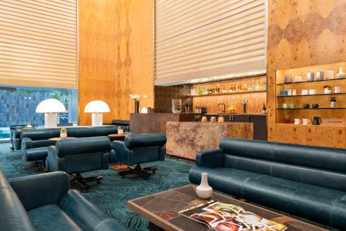 a lobby with leather couches and a bar at The Delphi Downtown LA in Los Angeles