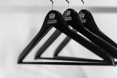 a group of black utensils hanging from a rack at Hotel London B&B in Skopje