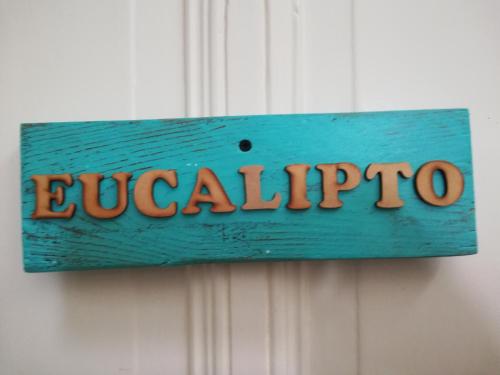 a blue sign that says eucalypto on a wall at HOTEL Boutique Casablanca Adrogué in Adrogué
