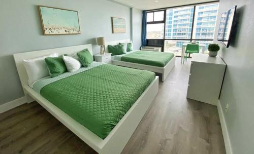 a living room with two beds and a couch at Ocean Side Inn Studios in Daytona Beach