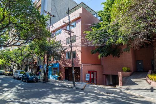 an empty street in front of a pink building at Suites 259 Condesa in Mexico City