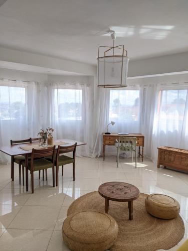 a living room with a table and a dining room at Appartement de charme Chez Soa in Antananarivo