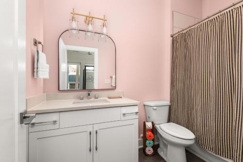 a bathroom with a sink and a toilet and a mirror at Mason Lofts at West End in Nashville