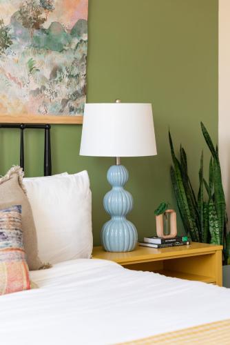 a bedroom with a bed with a lamp on a table at Mason Lofts at West End in Nashville