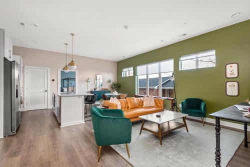 a living room with green walls and a couch at Mason Lofts at West End in Nashville