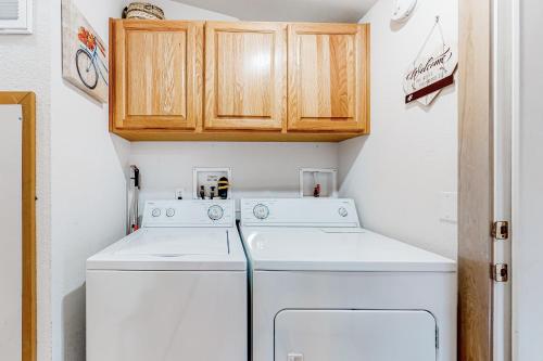 a small laundry room with a washer and dryer at Riverfront Retreat in Sunriver