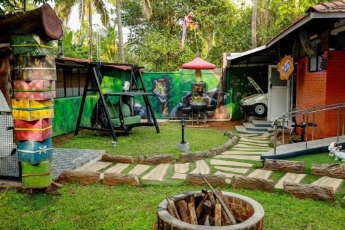 a group of tents in a yard with a fire pit at Belljem Homes -your own private resort -2 BHK GF in Trichūr