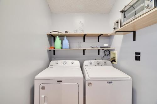 a laundry room with two washing machines and shelves at Premier Cozy Cabin - Free Amenities & Comm Indoor Pools in Bushkill