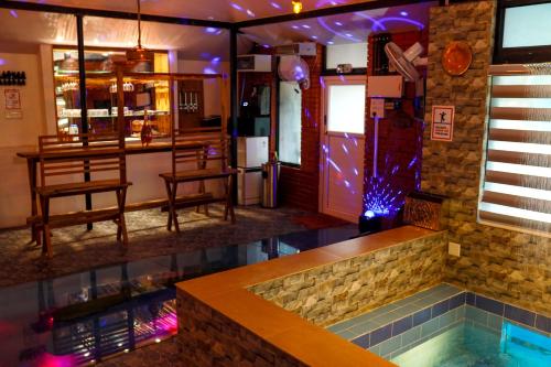 a pool in a bar with chairs and a table at Belljem Homes -your own private resort -2 BHK GF in Trichūr
