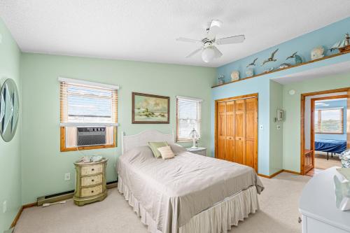 a bedroom with a bed and a ceiling fan at Catch 'n' Cook Cottage in Frisco
