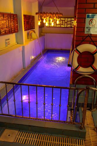 a large blue swimming pool in a building at Belljem Homes -your own private resort -2 BHK GF in Trichūr