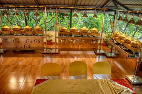 a room with a table and two chairs in it at Belljem Homes -your own private resort -2 BHK GF in Trichūr