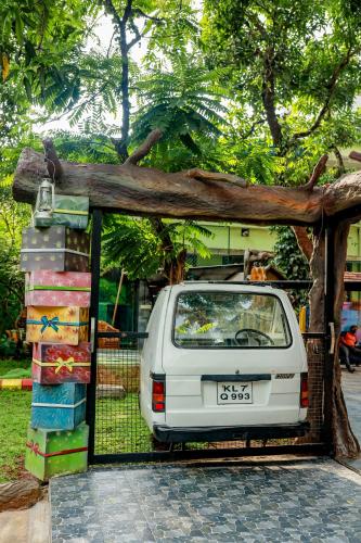 a white car parked in front of a fence at Belljem Homes -your own private resort -2 BHK GF in Trichūr