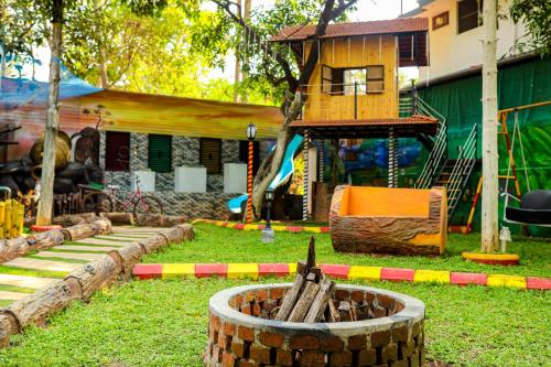 a playground with a house and a play structure at Belljem Homes -your own private resort -2 BHK GF in Trichūr