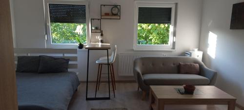 a living room with a couch and a table at Apartman Jakša in Prijedor